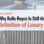 Title image for case study “Why Rolls-Royce Is Still the Definition of Luxury” featuring a close-up luxury car grille with the Spirit of Ecstasy hood ornament in the background and bold modern typography overlay.